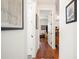 Inviting hallway with hardwood floors leading to a sunlit living room, enhanced by stylish artwork on the walls at 631 W Park St, Lakeland, FL 33803