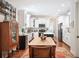 Bright kitchen featuring white cabinets, island, and wooden dining table at 631 W Park St, Lakeland, FL 33803