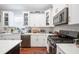 Kitchen featuring white cabinets, stainless appliances, subway tile, and plenty of counter space at 631 W Park St, Lakeland, FL 33803