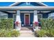 Inviting front porch with brick pillars and space for seating with plants at 631 W Park St, Lakeland, FL 33803