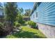 Well-maintained side yard with manicured shrubs and lush green lawn, adding to the home's curb appeal at 631 W Park St, Lakeland, FL 33803