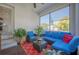 Bright sunroom with cozy blue seating, red patterned rug, and ample natural light from large screened windows at 631 W Park St, Lakeland, FL 33803