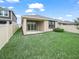 Expansive backyard with a covered patio, sliding glass doors, and a secure fence for outdoor enjoyment at 6533 Great Bear Dr, Lakeland, FL 33805