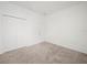 Bedroom featuring neutral carpeting, white walls, and a white closet at 6533 Great Bear Dr, Lakeland, FL 33805