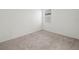 Bedroom featuring neutral carpeting, white walls, and a window letting in natural light at 6533 Great Bear Dr, Lakeland, FL 33805