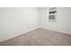 Bedroom featuring neutral carpeting, white walls, and a window letting in natural light at 6533 Great Bear Dr, Lakeland, FL 33805