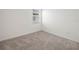 Bedroom featuring neutral carpeting, white walls, and a window letting in natural light at 6533 Great Bear Dr, Lakeland, FL 33805