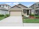 Charming single Gathering home boasting a well-manicured lawn and a two-car garage at 6533 Great Bear Dr, Lakeland, FL 33805