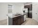 Kitchen island featuring stainless steel appliances, granite countertops, and wooden cabinetry at 6533 Great Bear Dr, Lakeland, FL 33805
