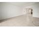 Open living room with tile flooring leading into the dining and kitchen areas at 6533 Great Bear Dr, Lakeland, FL 33805