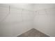 Walk-in closet has white walls with white racks and gray carpet at 6533 Great Bear Dr, Lakeland, FL 33805