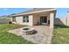 Inviting backyard with paver patio, cozy firepit, and sliding glass doors enhancing outdoor living at 6769 Se 3Rd Loop, Ocala, FL 34472