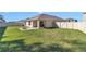 Large backyard with a covered patio, fire pit, and a privacy fence, perfect for outdoor entertaining at 6769 Se 3Rd Loop, Ocala, FL 34472