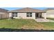 Expansive backyard featuring a covered patio, fire pit, and well-maintained lawn for relaxation at 6769 Se 3Rd Loop, Ocala, FL 34472