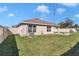 Spacious backyard featuring a well-maintained lawn, cozy patio area, and modern home exterior at 6769 Se 3Rd Loop, Ocala, FL 34472