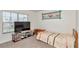 Bright bedroom with carpet, a chest and side table and a large window at 6769 Se 3Rd Loop, Ocala, FL 34472