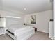 Bright bedroom featuring a king bed, neutral carpet, and stylish wall decor at 6769 Se 3Rd Loop, Ocala, FL 34472
