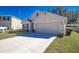 Single-story home with a two-car garage, concrete driveway, and landscaped front yard at 6769 Se 3Rd Loop, Ocala, FL 34472