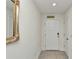 Hallway with neutral-colored walls, tile flooring and white door frames at 6769 Se 3Rd Loop, Ocala, FL 34472