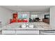 Kitchen with a central island featuring a double sink, and open sight lines to a dining and seating area at 6769 Se 3Rd Loop, Ocala, FL 34472