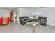 Inviting living room features leather sofas, a glass coffee table, and large windows, offering comfort and style at 6769 Se 3Rd Loop, Ocala, FL 34472
