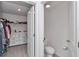Functional walk-in closet with built-in shelving and drawers leading to a water closet at 6769 Se 3Rd Loop, Ocala, FL 34472