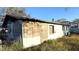 Exterior shot of home featuring boarded-up windows, showing deferred maintenance and renovation potential at 739 Ellerbe Way, Lakeland, FL 33801