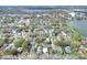 Aerial view of property nestled in a neighborhood setting with lush tree coverage, with the home marked by a red arrow at 810 Orange Park Ave, Lakeland, FL 33801