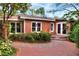 Home's backyard showcasing a brick patio and lush greenery at 810 Orange Park Ave, Lakeland, FL 33801