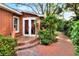 Patio view of a backyard with brick patio and well maintained landscape at 810 Orange Park Ave, Lakeland, FL 33801