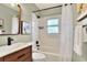 Modern bathroom featuring a stylish vanity with dark fixtures, a bathtub with shower, and neutral tones at 810 Orange Park Ave, Lakeland, FL 33801