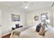 Cozy bedroom with soft natural light, featuring a large window, ceiling fan, and hardwood floors at 810 Orange Park Ave, Lakeland, FL 33801