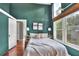 Cozy bedroom features a bed with white bedding, bedside tables, and a bright window at 810 Orange Park Ave, Lakeland, FL 33801