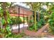 View of covered carport surrounded by privacy lattice and lush landscaping at 810 Orange Park Ave, Lakeland, FL 33801