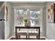 Cozy breakfast nook with a small table, seating for two, and bright natural light from the large window at 810 Orange Park Ave, Lakeland, FL 33801