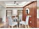 Dining room with hardwood floors, glass table, and built-in shelving for storage and display at 810 Orange Park Ave, Lakeland, FL 33801