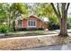 Charming single-story home with brick trim, mature trees, and a well-manicured front yard at 810 Orange Park Ave, Lakeland, FL 33801