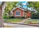 Exterior view of a charming single story home with mature landscaping and brick walkway at 810 Orange Park Ave, Lakeland, FL 33801