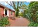 Charming single-story home featuring a brick-paved walkway leading to the front entrance, bordered by lush landscaping at 810 Orange Park Ave, Lakeland, FL 33801