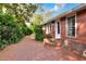 Charming single-story home featuring a brick-paved walkway leading to the front entrance, bordered by lush landscaping at 810 Orange Park Ave, Lakeland, FL 33801