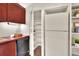 Kitchen featuring dark wood cabinets, a walk-in pantry, and a white refrigerator at 810 Orange Park Ave, Lakeland, FL 33801
