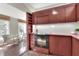 Kitchen with dark cabinetry, built-in shelving, and stainless steel oven at 810 Orange Park Ave, Lakeland, FL 33801