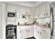 This kitchen features white cabinets, black hardware, and stainless steel appliances at 810 Orange Park Ave, Lakeland, FL 33801