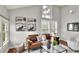Living room featuring a brown leather couch, modern art, hardwood floors, and plentiful natural light at 810 Orange Park Ave, Lakeland, FL 33801