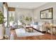 Bright living room featuring hardwood floors, neutral décor, and an abundance of natural light at 810 Orange Park Ave, Lakeland, FL 33801