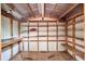 Interior view of the shed, showcasing ample shelving for storage, a workbench, and a corrugated metal roof at 810 Orange Park Ave, Lakeland, FL 33801