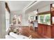 Bright sitting room with hardwood floors, neutral furniture, and an open doorway to the living area at 810 Orange Park Ave, Lakeland, FL 33801