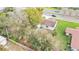 Aerial view of house with privacy trees in urban setting at 827 Sikes Blvd, Lakeland, FL 33815