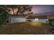 Backyard with storage shed, wooden fence and partial view of house at sunset at 827 Sikes Blvd, Lakeland, FL 33815