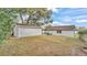 Backyard with storage shed, wooden fence and partial view of house at 827 Sikes Blvd, Lakeland, FL 33815